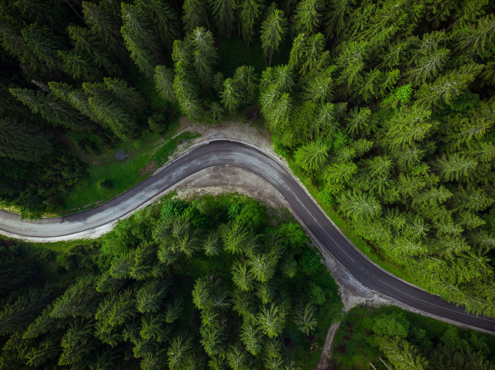 Winding road in forest, aerial drone view, road trip concept Winding road in forest, aerial drone view, road trip concept.